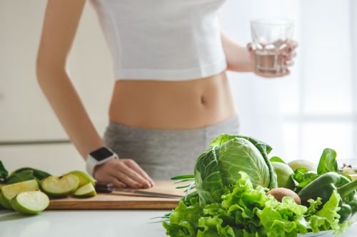 young woman making detox smoothie home